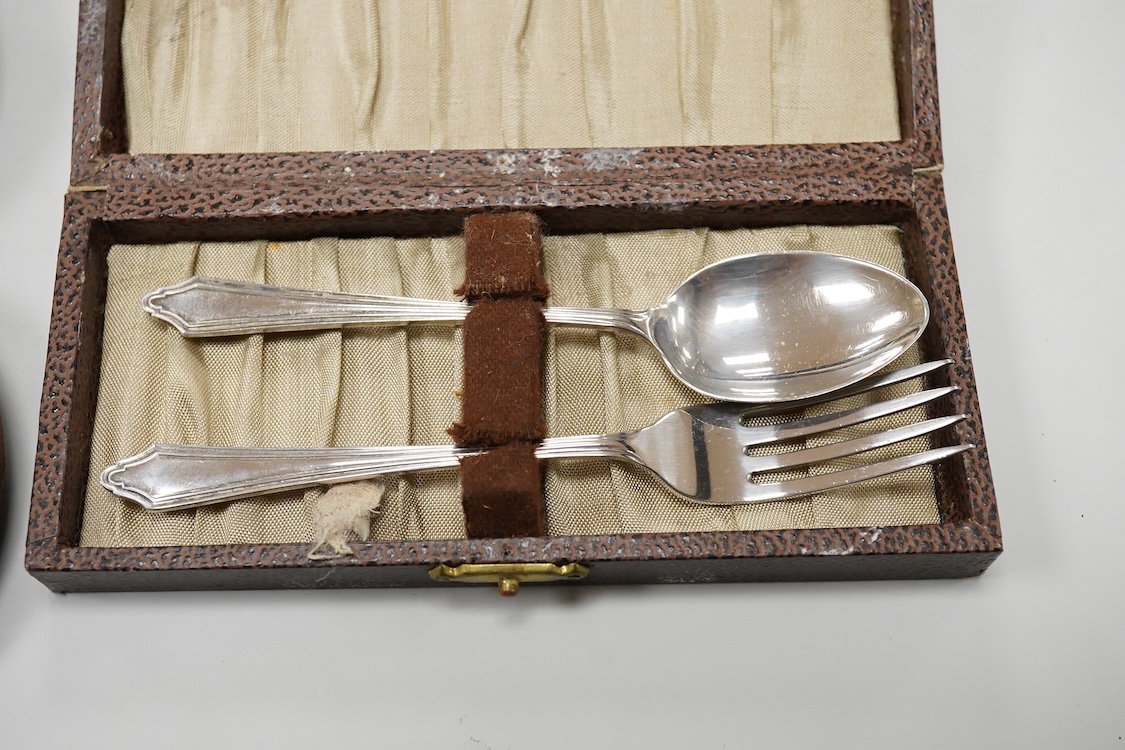 A cased Edwardian silver christening pair by Goldsmiths and Silversmiths Co Ltd, London, 1905, two cased sets of six silver teaspoons, one with a pair of sugar tongs, one other cased silver christening pair, a cased set
